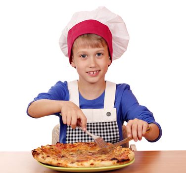 happy boy chef eating pizza