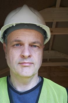 portrait of a mature male builder wearing hard hat