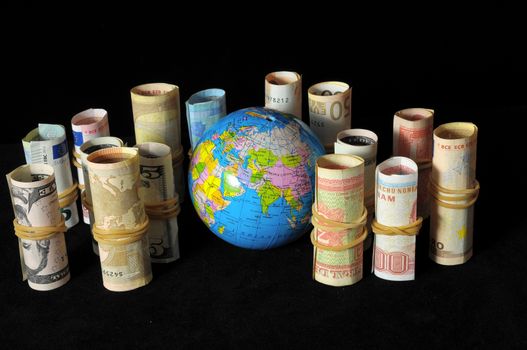 The Planet Earth and Rolled Money Financial Concept