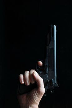 Gun and a Hand on a Black Background
