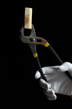 Pliers and a Hand on a Black Background