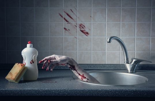 Bloody hand in kitchen sink, Halloween concept or crime scene 