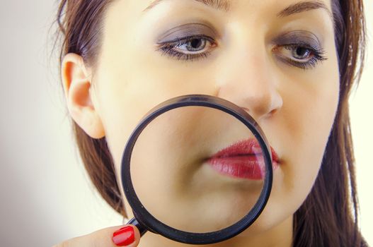 An image of Women with magnifying glass over her lips