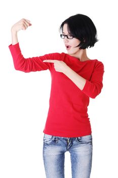 Young woman shows her biceps. Isolated on the white background.