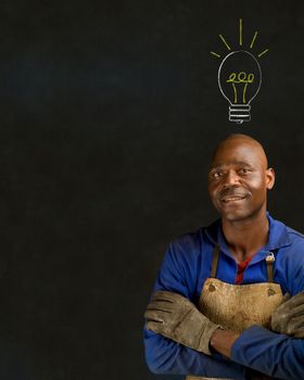 African American black man industrial worker with chalk light bulb on a blackboard background
