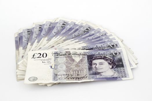 Twenty pounds sterling notes on a white background