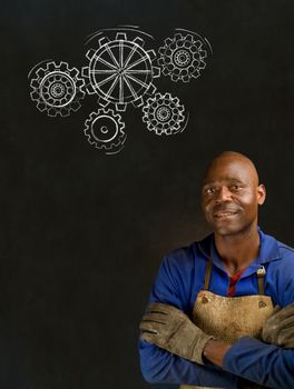 African American black man industrial worker with chalk gears on a blackboard background