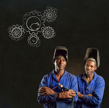 African American black men industrial workers with chalk hamster gears on a blackboard background