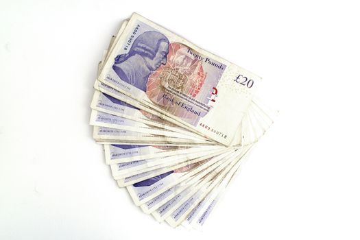 Twenty pounds sterling notes on a white background