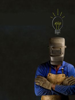 African American black man industrial worker with chalk light bulb on a blackboard background