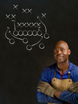 African American black man industrial worker with chalk game plan on a blackboard background