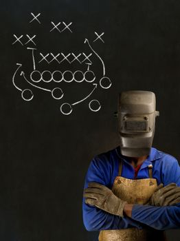 African American black man industrial worker with chalk game plan on a blackboard background