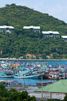 Fishing boats near village with mountain background