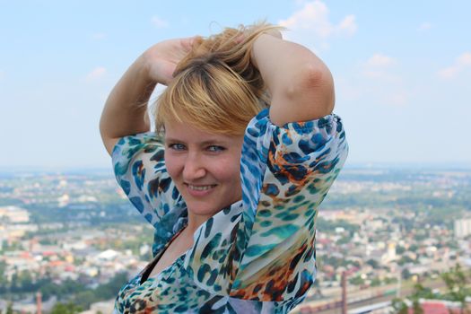 blue-eyed sympathetic girl on the background of view of city