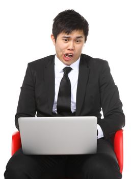 Asian businessman shocked surprise by laptop computer