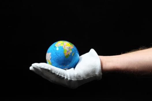 Planet Earth and a Hand on a Black Background