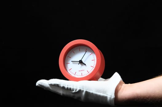 Clock And an Hand on a Black Background