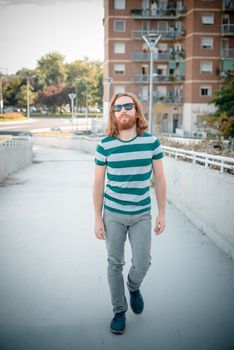 stylish hipster model with long red hair and beard lifestyle in the street