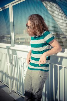 stylish hipster model with long red hair and beard lifestyle in the street