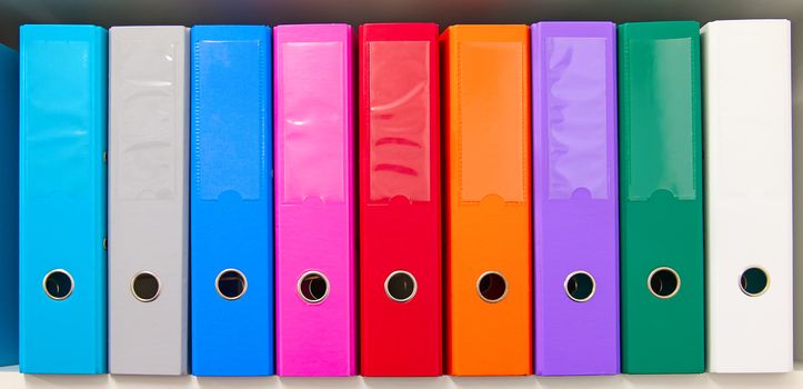 Colorful office folders on the bookshelf