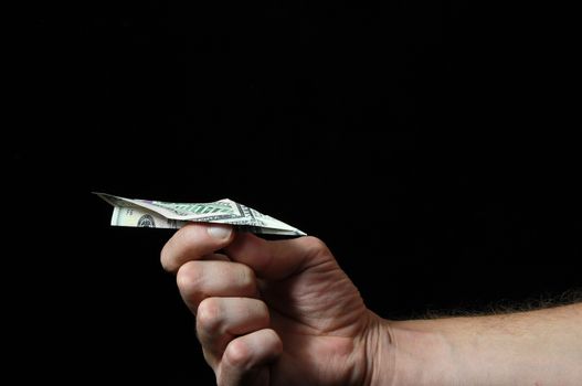 Airplane Dollar And an Hand on a Black Background