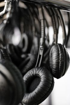 Close-up of many black pair of headphones.