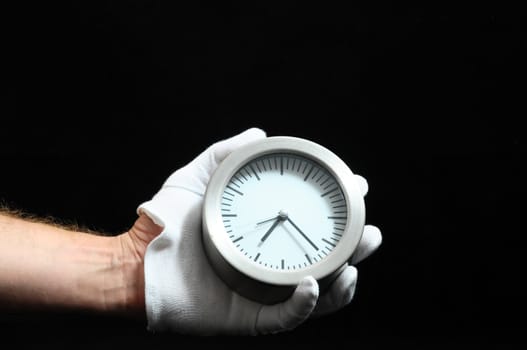 Clock And an Hand on a Black Background