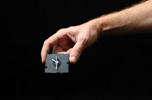 Clock And an Hand on a Black Background