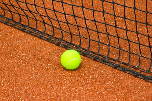 Bright yellow tennis ball on the court