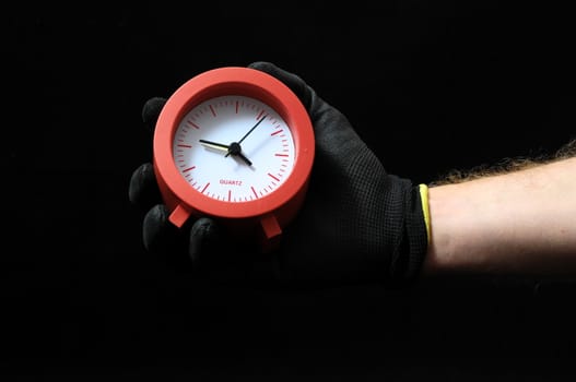 Clock And an Hand on a Black Background