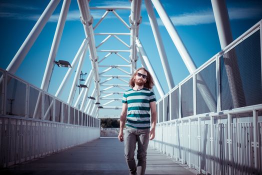 stylish hipster model with long red hair and beard lifestyle in the street