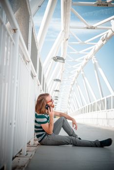 stylish hipster model with long red hair and beard lifestyle on the phone in the street