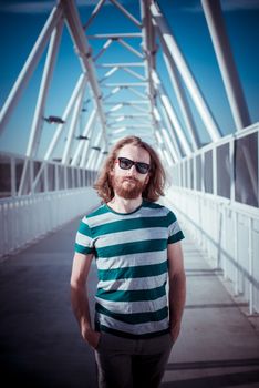 stylish hipster model with long red hair and beard lifestyle in the street