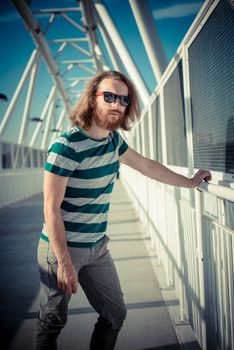 stylish hipster model with long red hair and beard lifestyle in the street