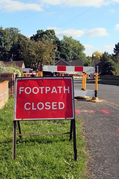 Road work warning signs and barriers in a street in England. 