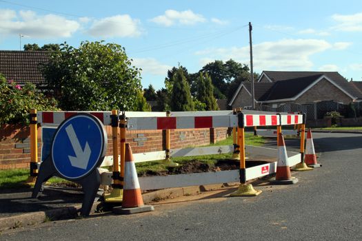 Road work warning signs and barriers in a street in England. 