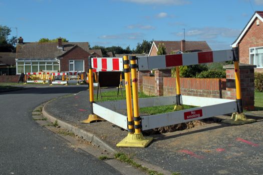 Road work warning signs and barriers in a street in England. 