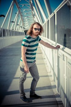 stylish hipster model with long red hair and beard lifestyle in the street