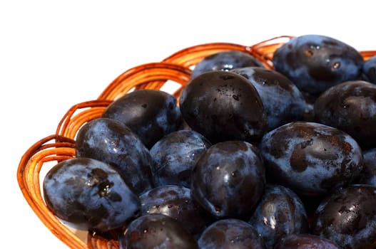 Plums in a basket close-up