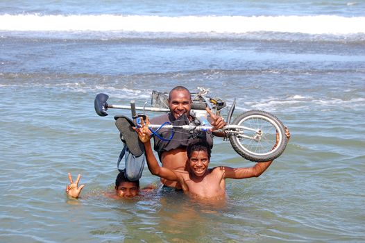 People with holding bycicle at river, Papua New Guinea