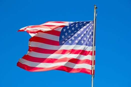 Flag of the United States against blue sky