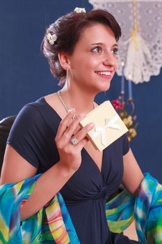 Elegant woman in evening dress with a gift in hand