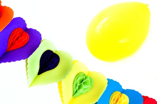 Party decoration - festoon and yellow balloon on white background