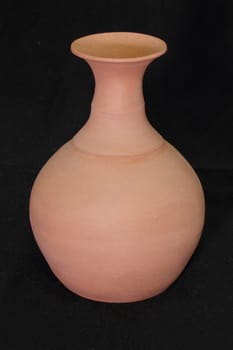 Clay jug on a black background
