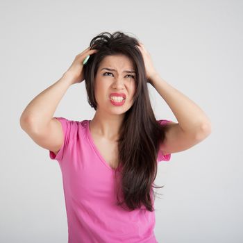 shocked woman losing hair on hairbrush