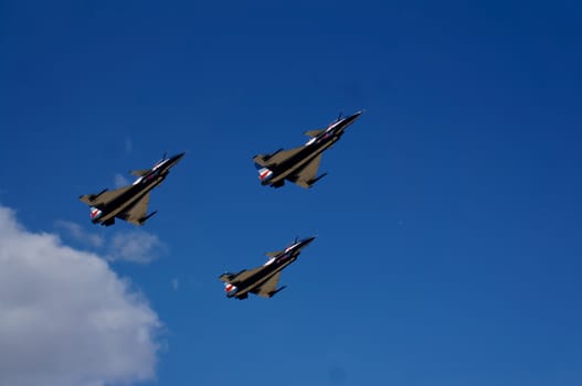 Three aircraft flying against the blue sky