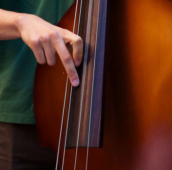 Young player playing the Bass with a  blue grass band