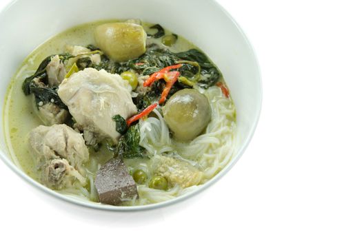 green chicken curry served with  rice vermicelli in white bowl over white background