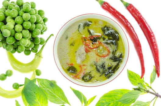 top view green chicken curry with fresh vegetable over white 