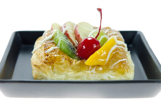 close up Apple Danish Topped With Glazed Fresh Fruit  on plate